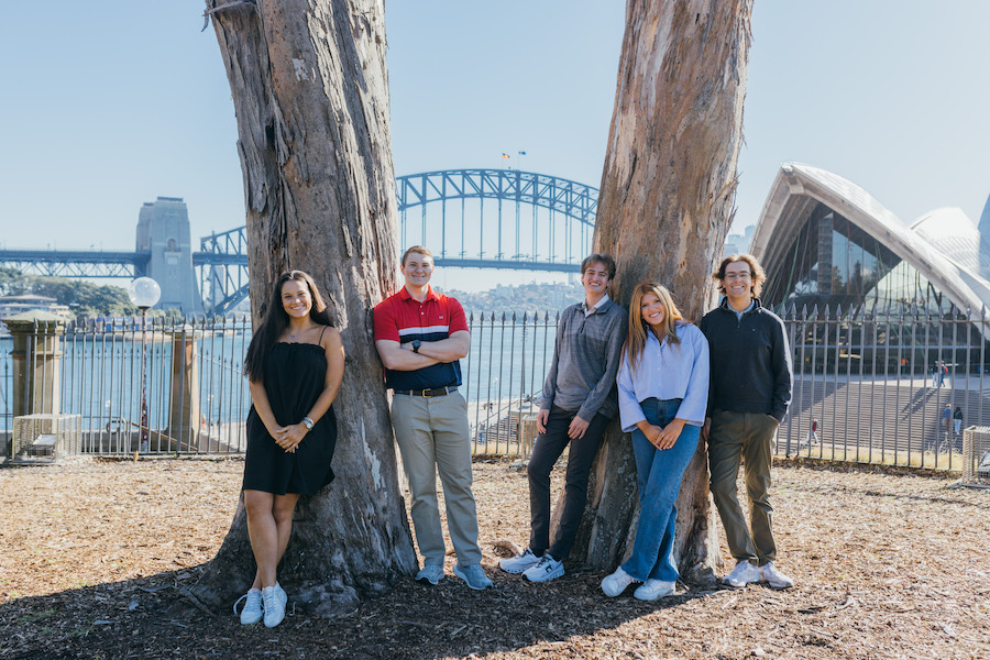 Group of students smiling by tree near Sydney Opera House