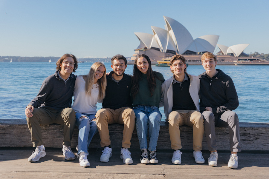 Group of students smiling in front of Sydney Opera House