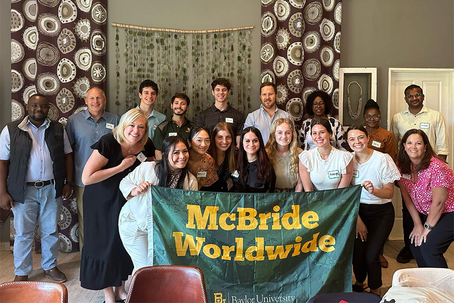 Business Mission Trip group with McBride Worldwide flag