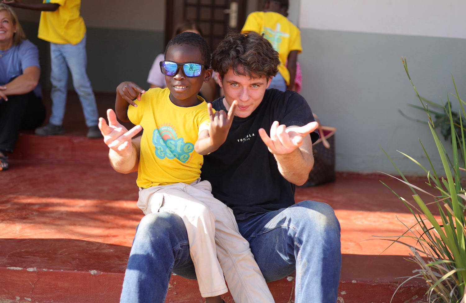 Student and local child in Zambia during a Baylor Business Mission Trip
