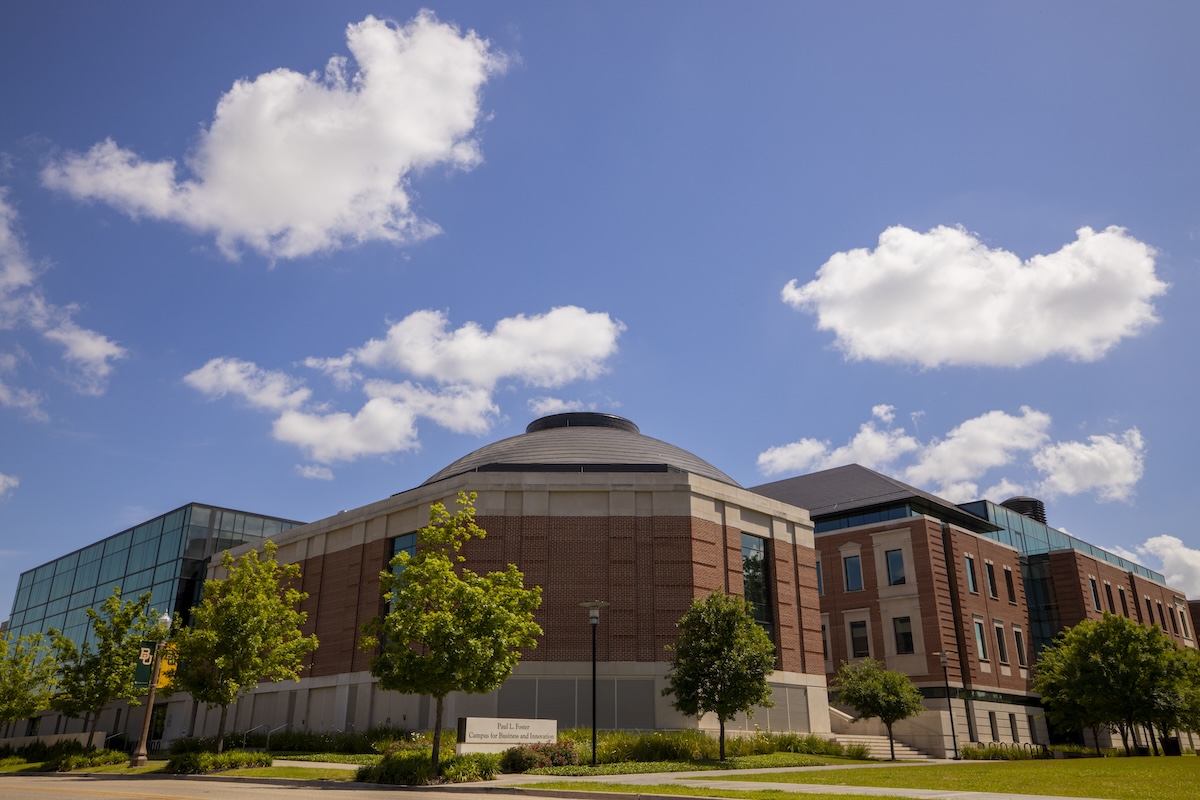 The Paul L. Foster Campus for Business and Innovation building against a blue sky with light clouds and during a sunny day