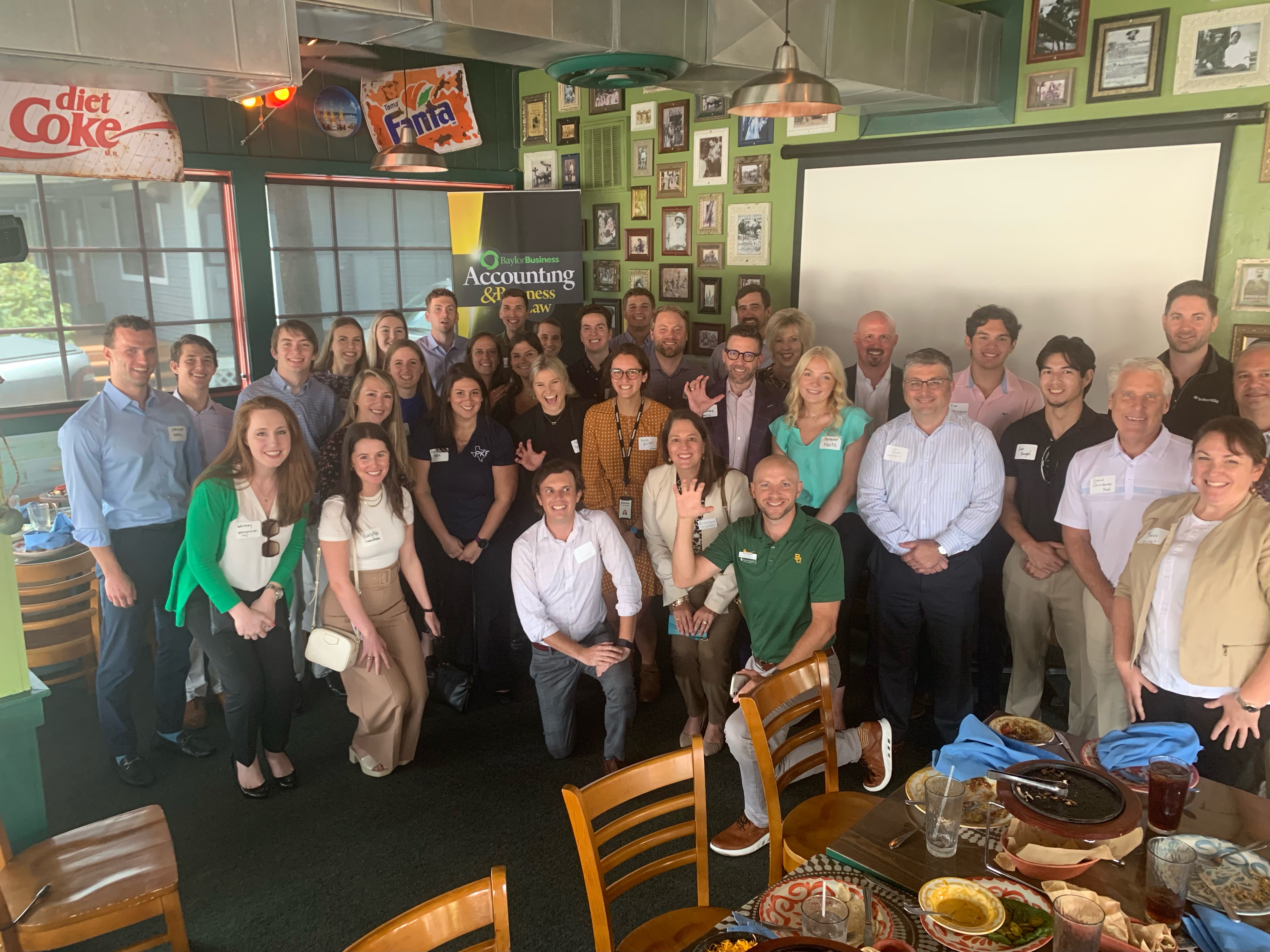 Baylor students posing in a restaurant for the Houston networking lunch
