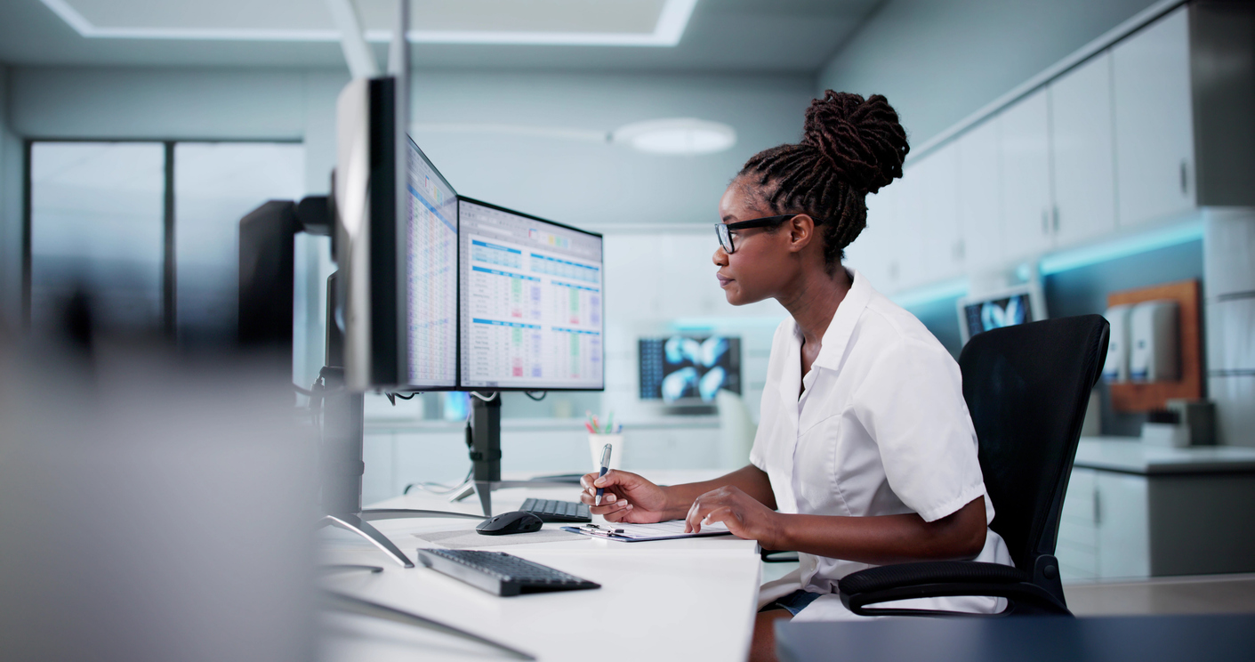 Female healthcare professional at a computer workstation
