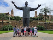 Statue of Nelson Mandela in South Africa with Baylor Grad Students surrounding the base