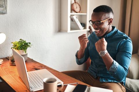 Man at laptop excited