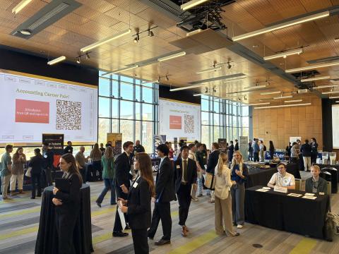 Accounting Career Fair - Spring 2026 students in a large room visiting company booths