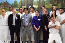 MBA students and prisoners posing for photo representing the prison entrepreneurship program pitch competition