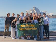 McBride - Sydney students holding flag with Sydney Opera House in background
