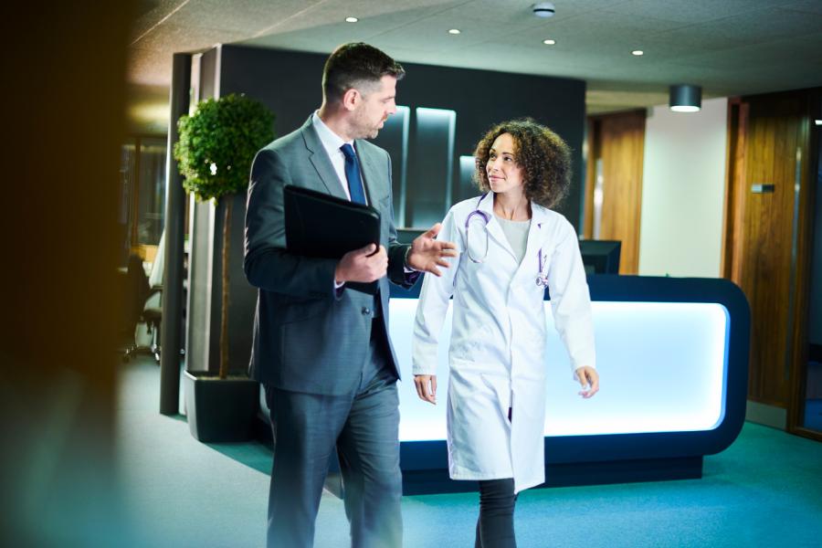Doctor and businessman walking and talking
