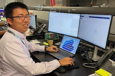 James Yang poses for photo at work