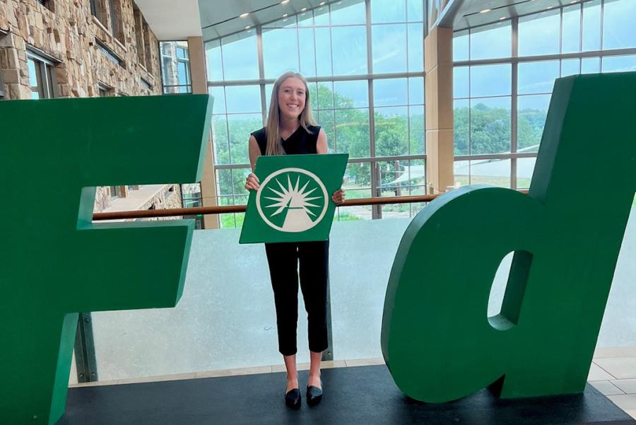 Kaitlyn Cornes poses for photo at work