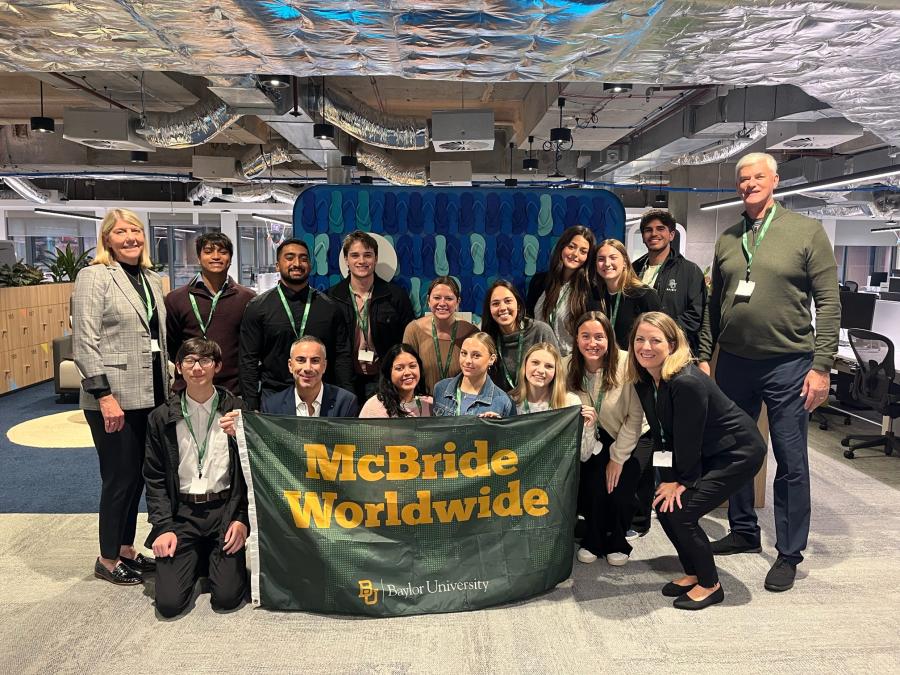 Study abroad students in Sydney, Australia holding a McBride Worldwide flag