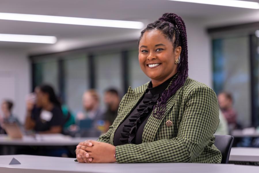 Professional woman smiling in an executive MBA classroom